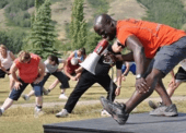 Garfield Wilson, personal trainer from CBC’s 10-part series Village on a Diet, leads the town of Taylor, BC in a warm up before a grueling endurance test.