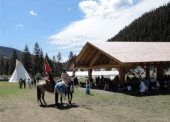 A covered meeting area within the Xats'ull Heritage Village is a prime location for local events and gatherings.